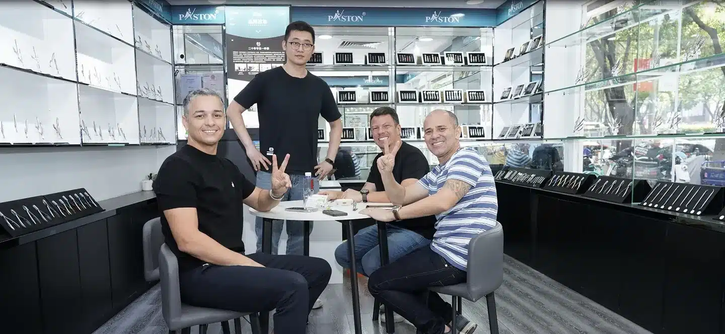 Visitors seated around a table in a YIFA PLAZA supplier showroom with product displays